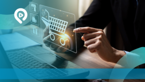 Close-up tangan seorang pria sedang berinteraksi dengan ikon keranjang belanja digital yang bercahaya di atas laptop, melambangkan transaksi e-commerce modern.